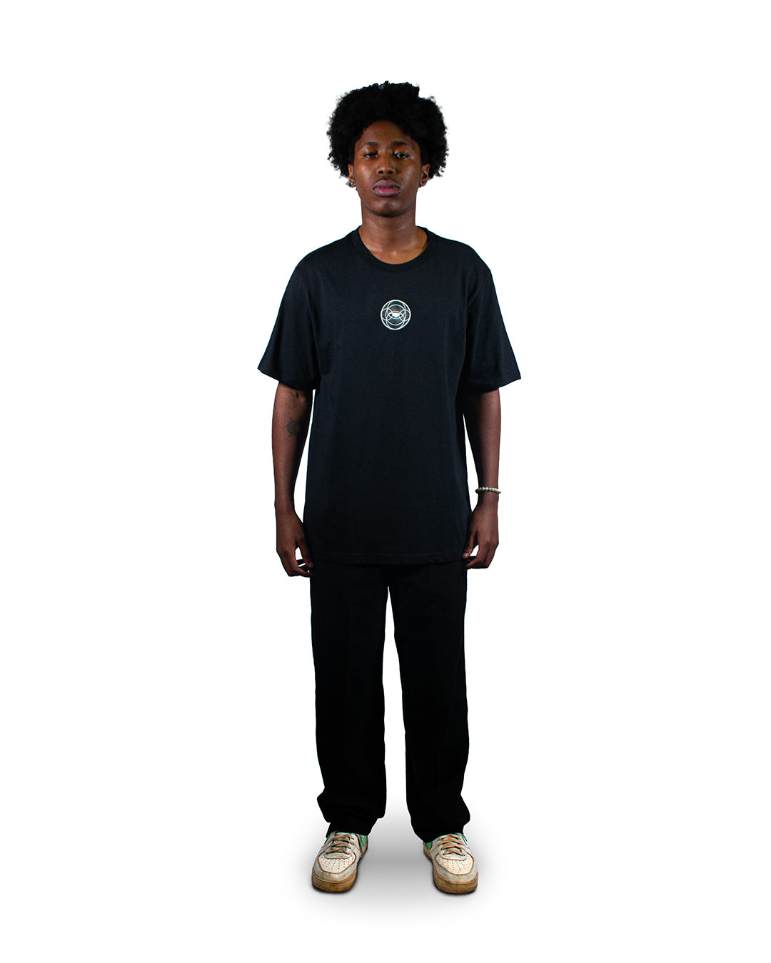Black t-shirt with surreal eye graphic print and balance scales.