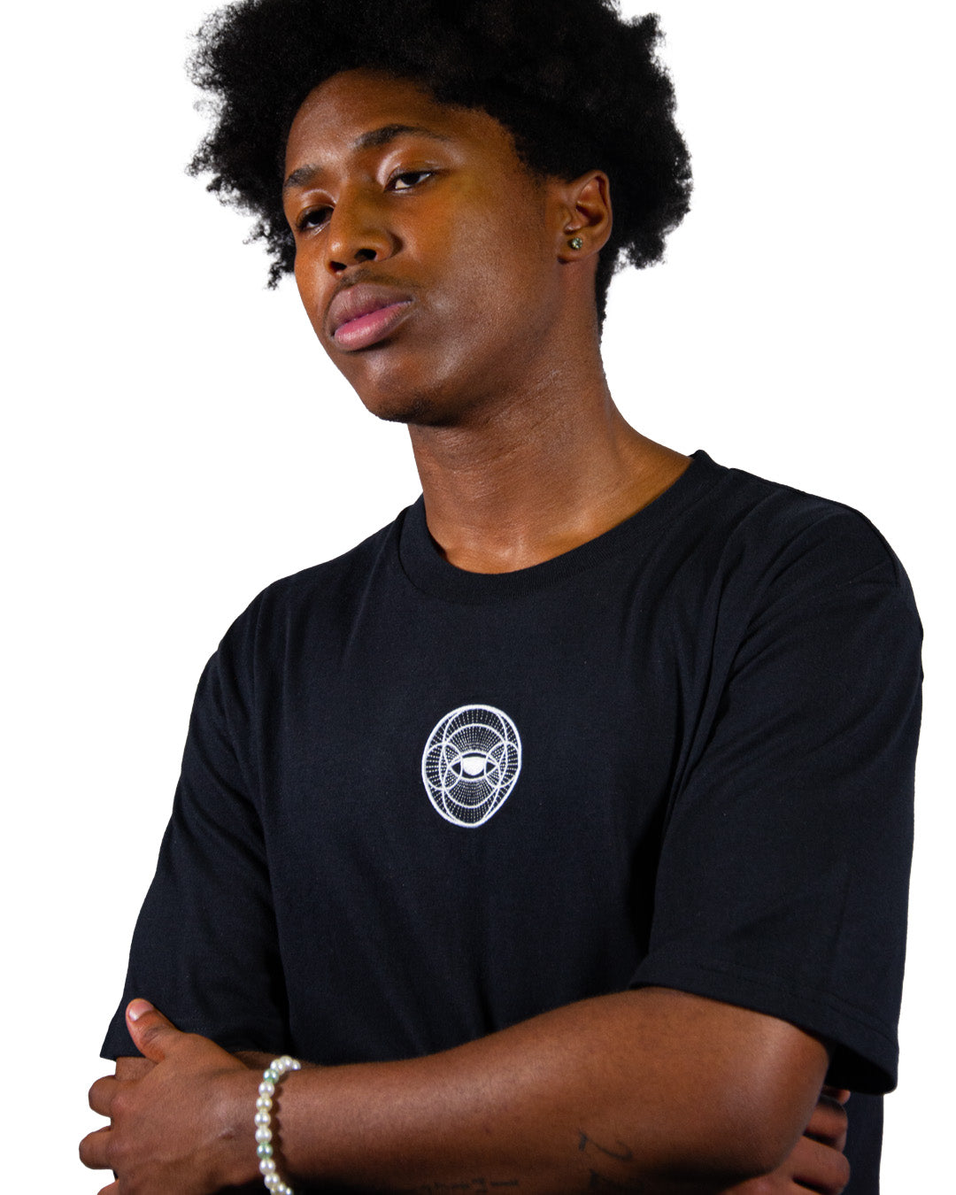 Black t-shirt with surreal eye graphic print and balance scales.